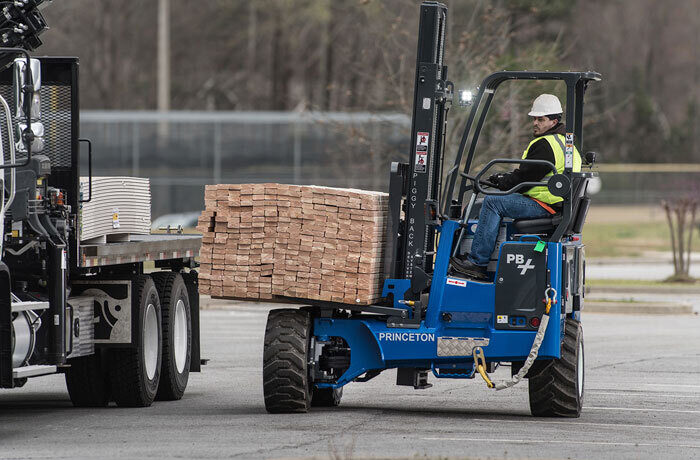 A man drives a forklift